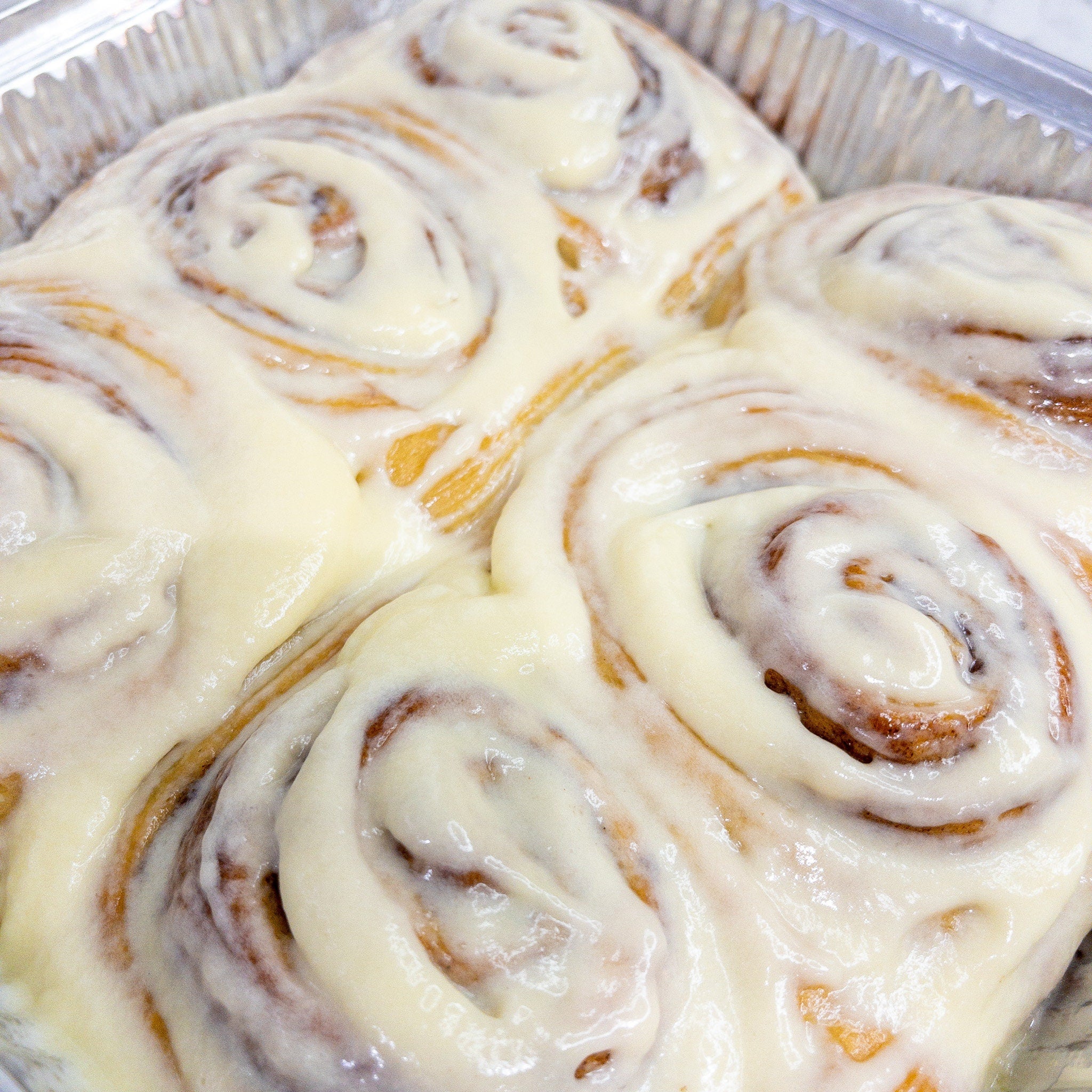 Close up picture of postal iced cinnamon buns